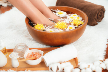 Woman indulges in blissful foot massage at luxurious spa salon while masseur give reflexology therapy in gentle day light ambiance resort or hotel foot spa. Quiescent