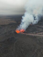 4K Aerial Drone Footage of an Active Volcanic Eruption with Lava Flow and Smoke over a Rugged Lava Field