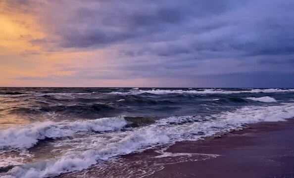 Romantyczny zach&oacute;d słońca nad morzem, pomarańczowy, ognisty zach&oacute;d, morska plaża, chmury, szum fal, wzburzone morze. 4k.
