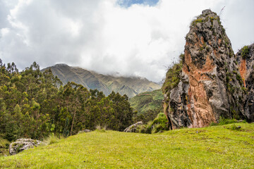 Scenic landscape with lush green terraces and misty Andean mountains at the Archaeological Site of Chinchero, Peru