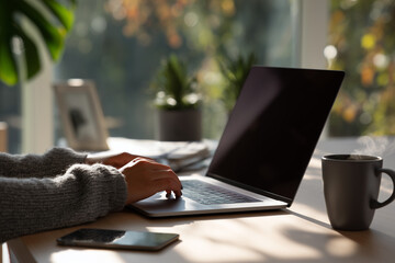 Minimalist Home Office with Businesswoman Working on Laptop Beside Coffee in Soft Natural Light