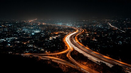 City lights streak along a highway at night, aerial view