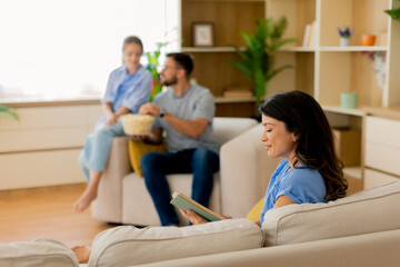 Friends enjoying a cozy afternoon at home with snacks and a good book
