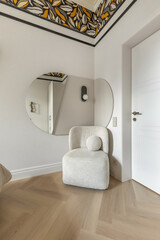 Cozy Chair and Abstract Mirror in Elegant Interior