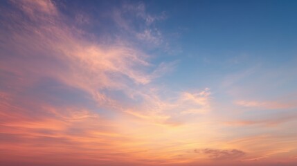 Vast tranquil sunrise sky with soft pastel clouds and golden morning glow
