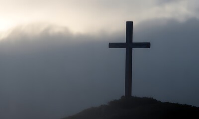 Naklejka premium Silhouetted Cross Against a Dramatic Cloudy Sky: A Powerful Symbol of Faith and Hope for Spiritual Reflection, Personal Growth, and Inspirational Imagery in Religious Contexts