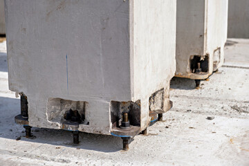 A concrete structure with visible bolts and a blue marking on it