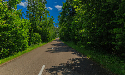 the road on a summer day. Highways, roadside and road line markings.