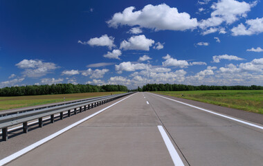 Road view on a summer day. Highways and bridge, roadside and white road line markings.