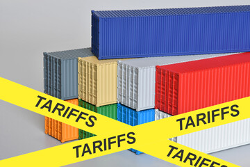 Shipping containers with warning yellow tape and "TARIFFS" written in the foreground
