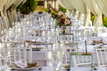 This image shows a beautifully set dining table for a formal event such as a wedding or a high-end dinner party