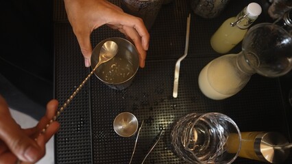 Cropped closeup hand bartender sterling mixed all ingredients alcohol liquor lime and syrup into...