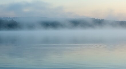 Fototapeta premium Gentle ripples on a tranquil lake, cool blue and green tones, misty