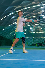Obraz premium Man playing tennis on a court