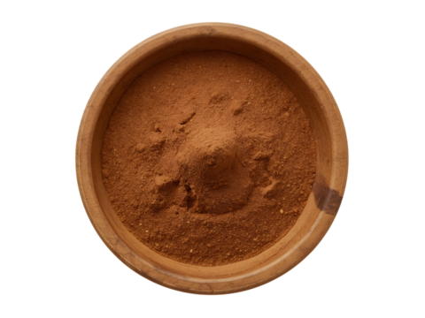 A Bowl of Cinnamon Powder: An overhead shot of a simple bowl holding a mound of aromatic cinnamon powder, its warm, earthy hues creating a pleasing contrast.