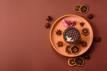Sweet tart, pie with chocolate and cream with fruit filling on a plate. Chocolate tart