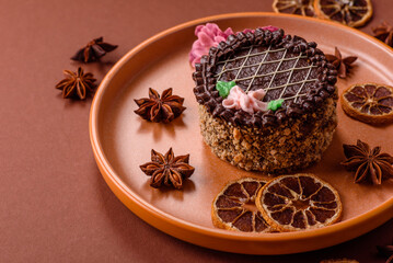 Sweet tart, pie with chocolate and cream with fruit filling on a plate. Chocolate tart