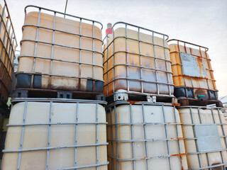 Industrial Bulk Container Storage Stacked IBC Liquid Transportation System Beige Plastic Material Steel Cage Pallets Environment Background Liquid Logistics Solution Warehousing Operation