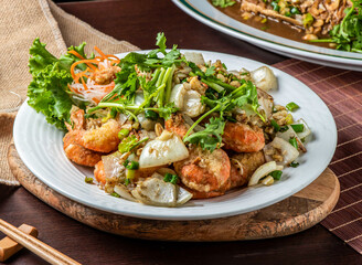 Crispy Fried Pepper Shrimp with Onions, Garlic, and Fresh Cilantro Garnish on White Plate, Closeup Side View