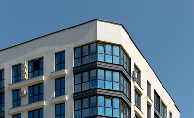 building in modern urban setting. Residential and commercial block with balconies, windows and