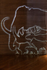 A light display showing the sizes of prehistoric animals, starting with a fox and ending with a mammoth.
