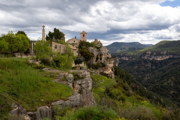Fototapeta premium View from Siurana viewpoint over the reservoir, village, and Church of Santa Maria de Siurana in Tarragona, Catalonia, Spain.