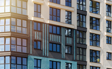 Closeup of modern high rise tower in urban metropolis. Multi story residential block with balconies,
