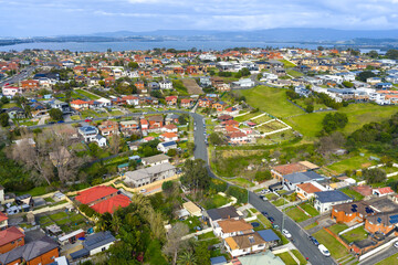 Drone aerial photograph of the town of Lake Heights with Lake Illawarra in the background in the greater Wollongong region of the Illawarra district on the south coast of New South Wales, Australia. 