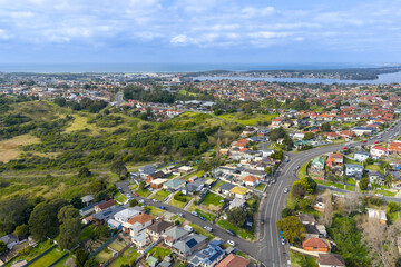 Drone aerial photograph of the town of Lake Heights with Lake Illawarra in the background in the greater Wollongong region of the Illawarra district on the south coast of New South Wales, Australia. 