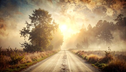 Fototapeta premium A sunlit country road through a misty forest at dawn