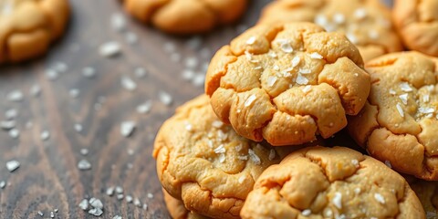 Golden brown salted caramel cookies, flaky edges, sea salt crystals, rich, background