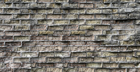 A brick wall damaged by time