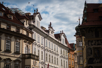 old town hall, historic buildings, likely in Prague's Old Town. The buildings feature classic European architecture, with ornate facades and detailed stonework