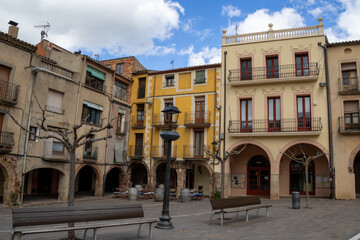 Fototapeta premium Main square of Prades, a charming village in Baix Camp, Tarragona, Catalonia, Spain, known as the “Red Town” for its distinctive reddish sandstone buildings.