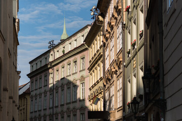 Naklejka premium old town, detailed facade of a historical building, likely in an older European city like Prague. The architecture appears to be Art Nouveau or a similar style, with ornate balconies, intricate plaste