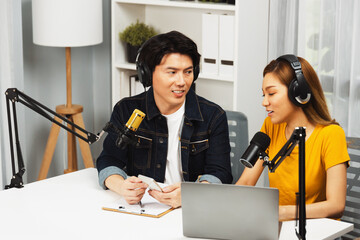 Smiling radio influencer hosts wearing headphones with channel social media online live streaming...