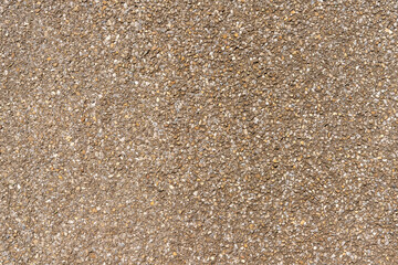Surface texture of road or footpath. Small pebbles of different colors on the surface.