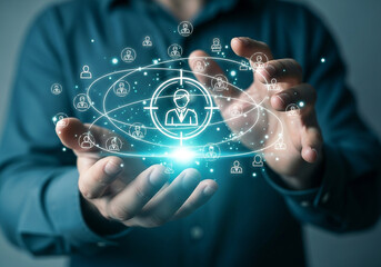 Photo of close up of hands holding a target icon with people icons floating around representing customer targeting