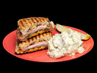 Grilled Panini Sandwich with Potato Salad and Pickle on Red Plate