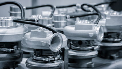 Several turbochargers arranged neatly in a workshop highlight the complexity and precision of...