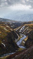 Autumn overcast day in the north of Iceland.           Small river flowing through beautiful canyon.