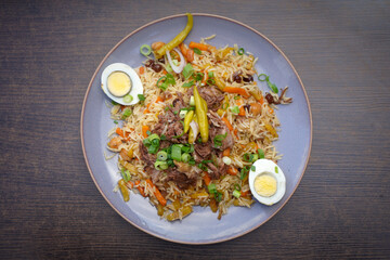 Plate of aromatic pilaf with boiled eggs and herbs