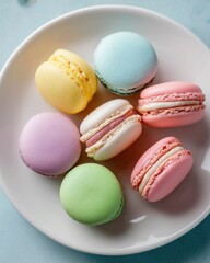 Obraz premium Assorted Colorful Macarons on White Plate Overhead View