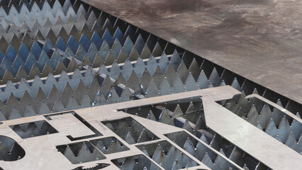 Obraz premium metal sheet is placed on the surface. plate is made of metal and has a rough texture. It is placed on the black tabletop of the laser plasma cutting