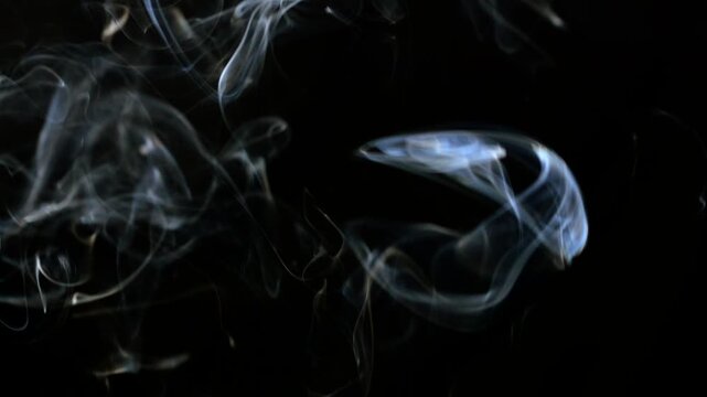 Smoke dissipating on a black background.
Graphic resources with elements of smoke and smoldering.
Futuristic video of smoke smoothly dissipating on a black isolated background