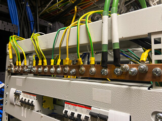 ground bus, electrical panel with cables, ground connection, grounding cables