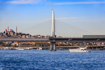 Golden Horn Metro Bridge with historic mosque and Istanbul cityscape, Turkey