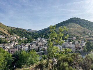 Scenic view of Le Bleymard village nestled in the Cévennes, seen from a forest vantage point. Perfect for rural, landscape, and nature photography.