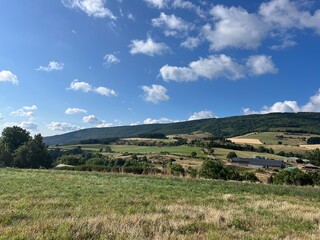 Stunning landscape showcasing fields and majestic mountains in the Cévennes region. Ideal for nature, rural, travel, and landscape photography themes.