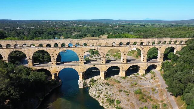 The Pont du Gard is an ancient Roman aqueduct, that is depicted  on five euro note. Summertime.